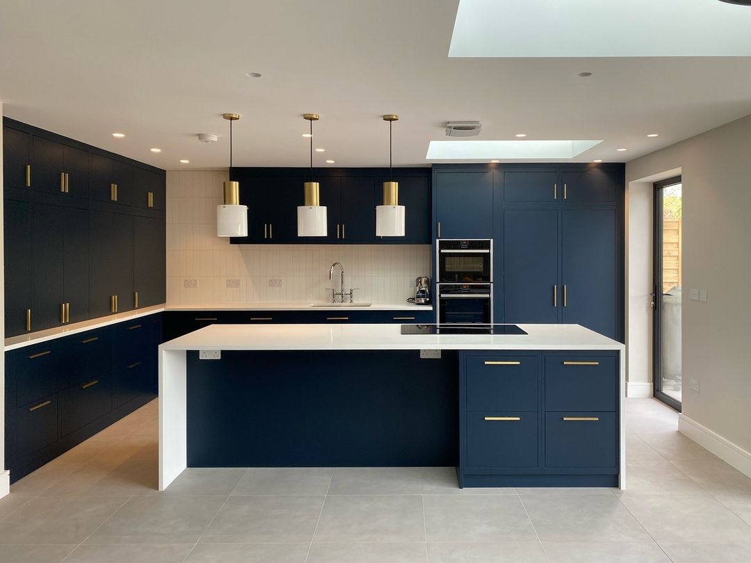 dark blue kitchen bespoke kitchen with gold bar handles